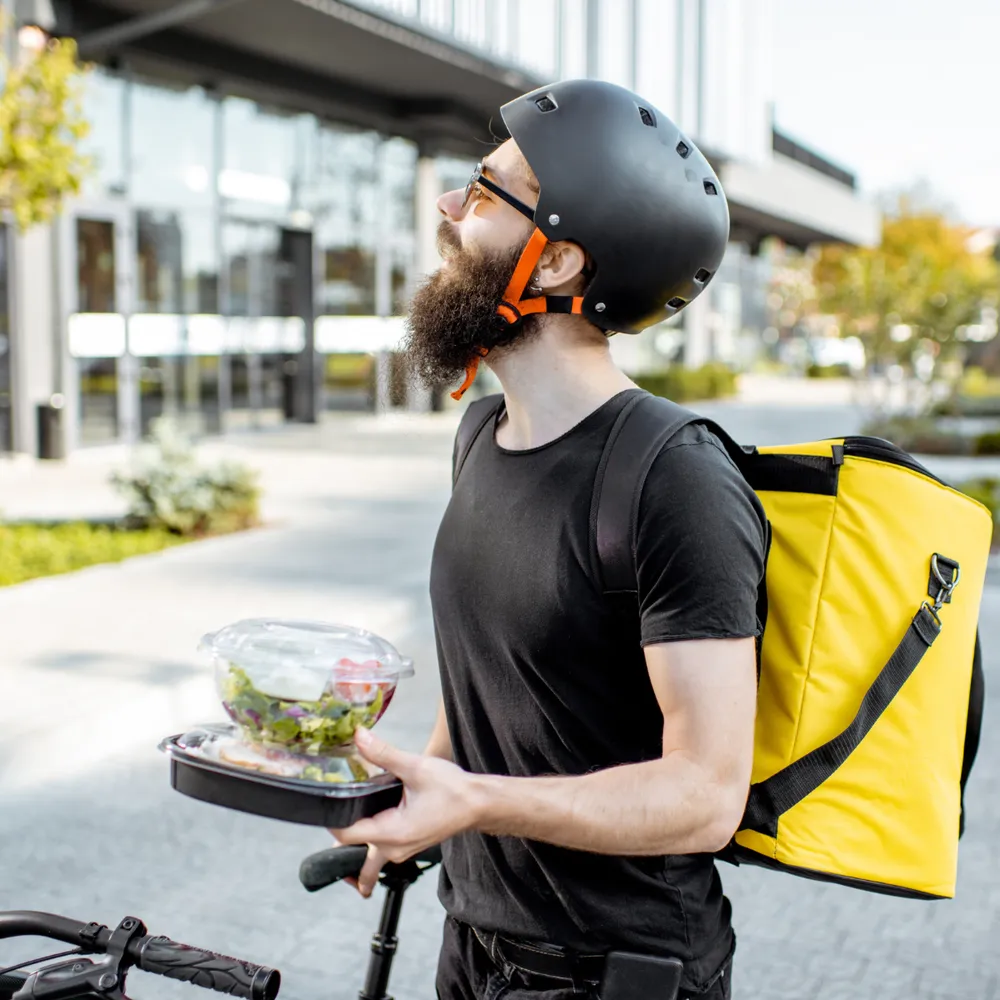 Courier in yellow hi-vis with a delivery bag