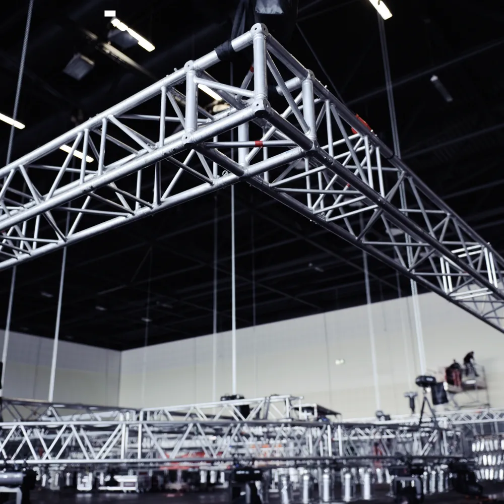 Aluminium lighting truss being rigged in an exhibition hall