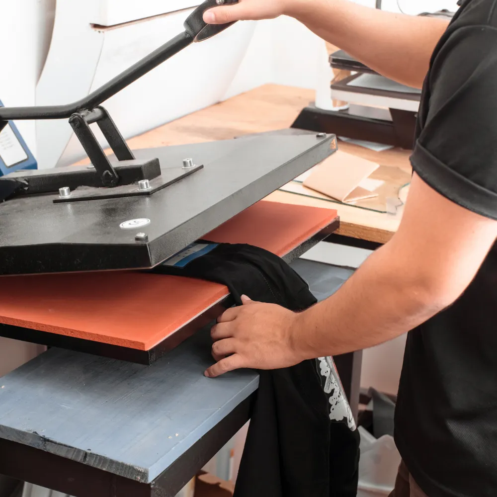 Heat press machine applying a printed transfer
