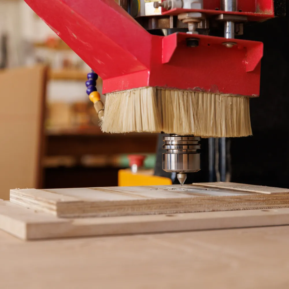 CNC drilling machine working a plywood panel in a joinery workshop