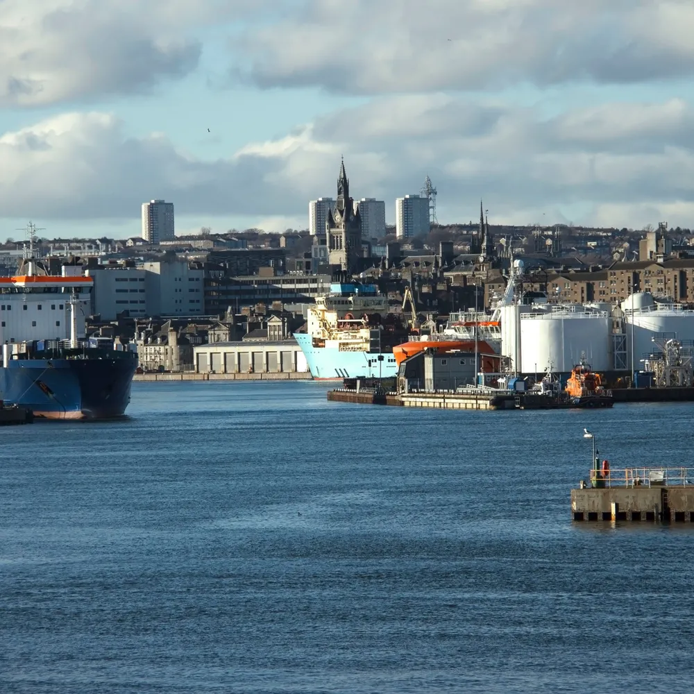 Offshore supply vessels in Aberdeen harbour with the city behind
