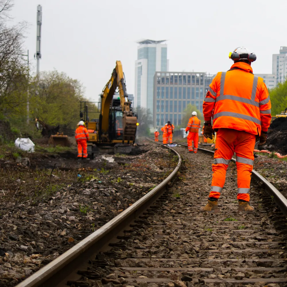 Rail workers in orange hi-vis on a track possession