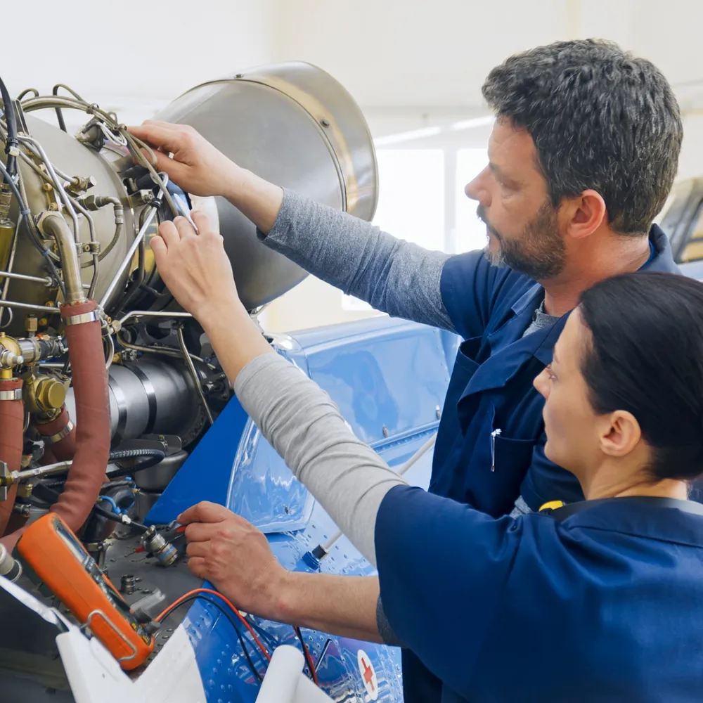 Engineers working on an aircraft engine