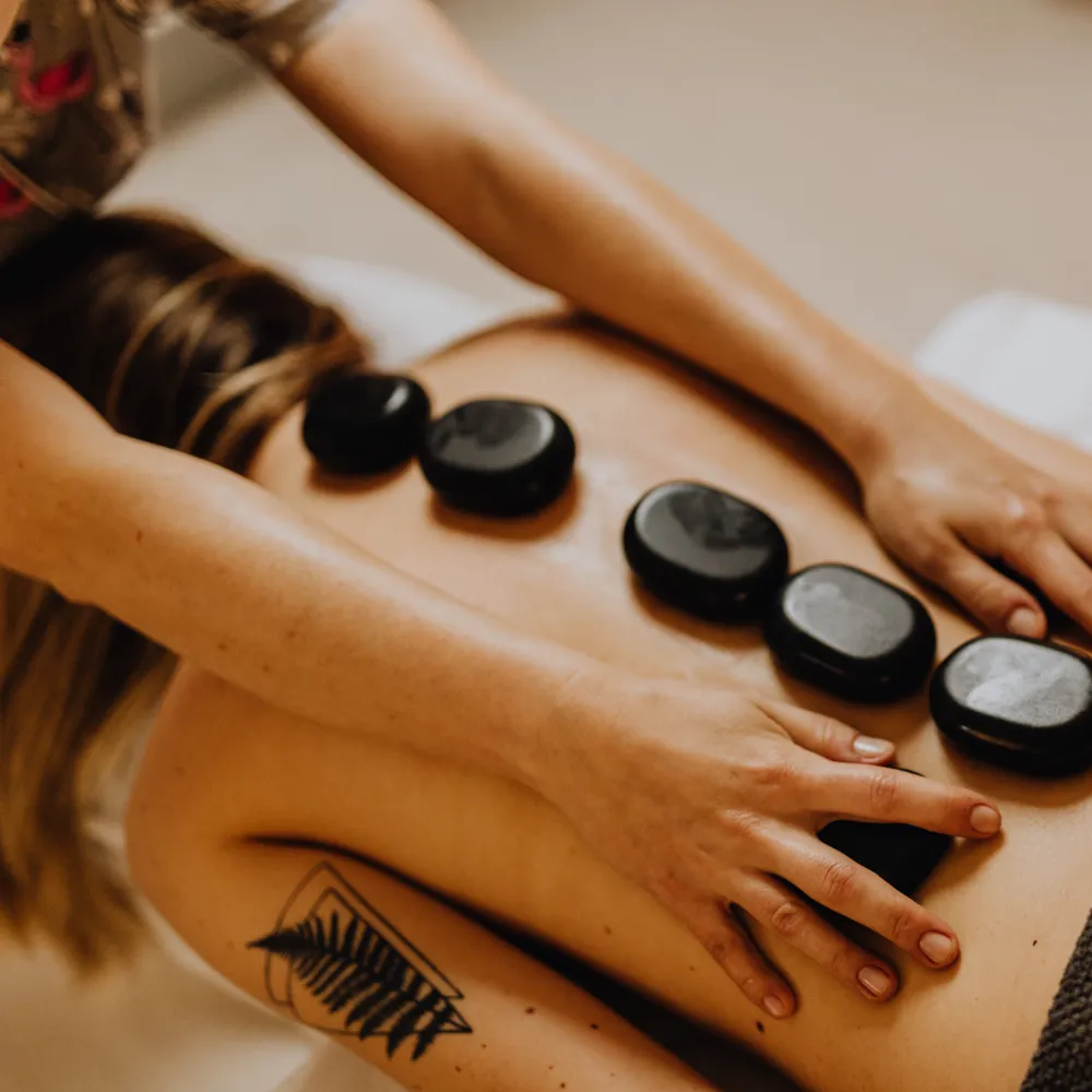 Hot stone massage in a spa treatment room