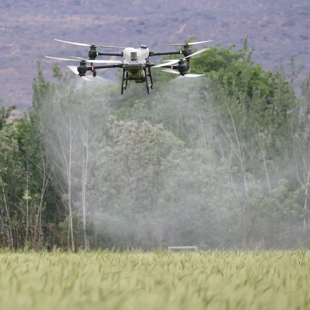 Agricultural spray drone working over a crop field