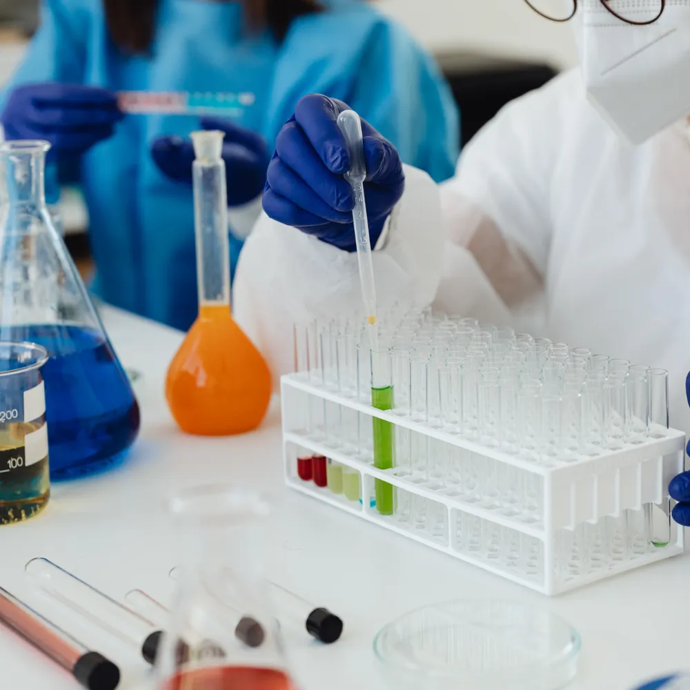 Lab technicians in gloves working with chemical samples