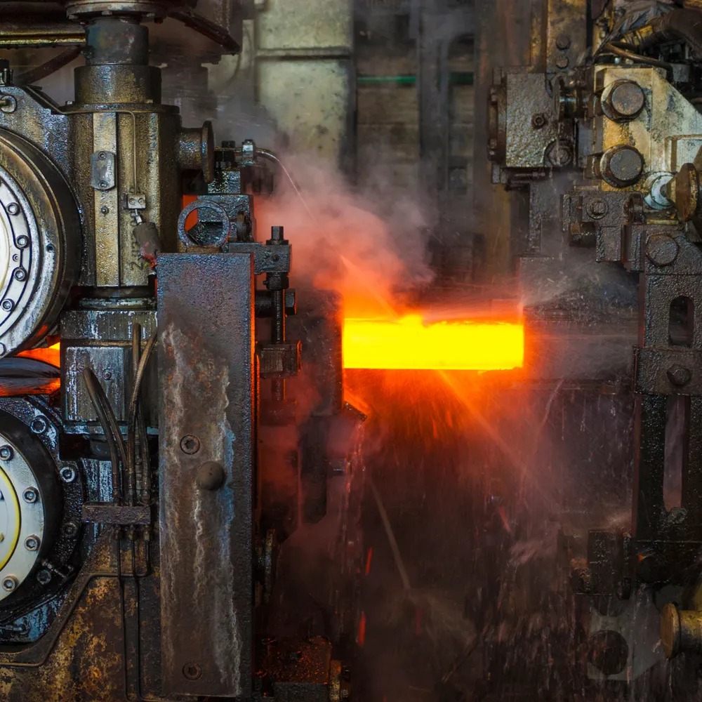 Red-hot steel bar in a rolling mill