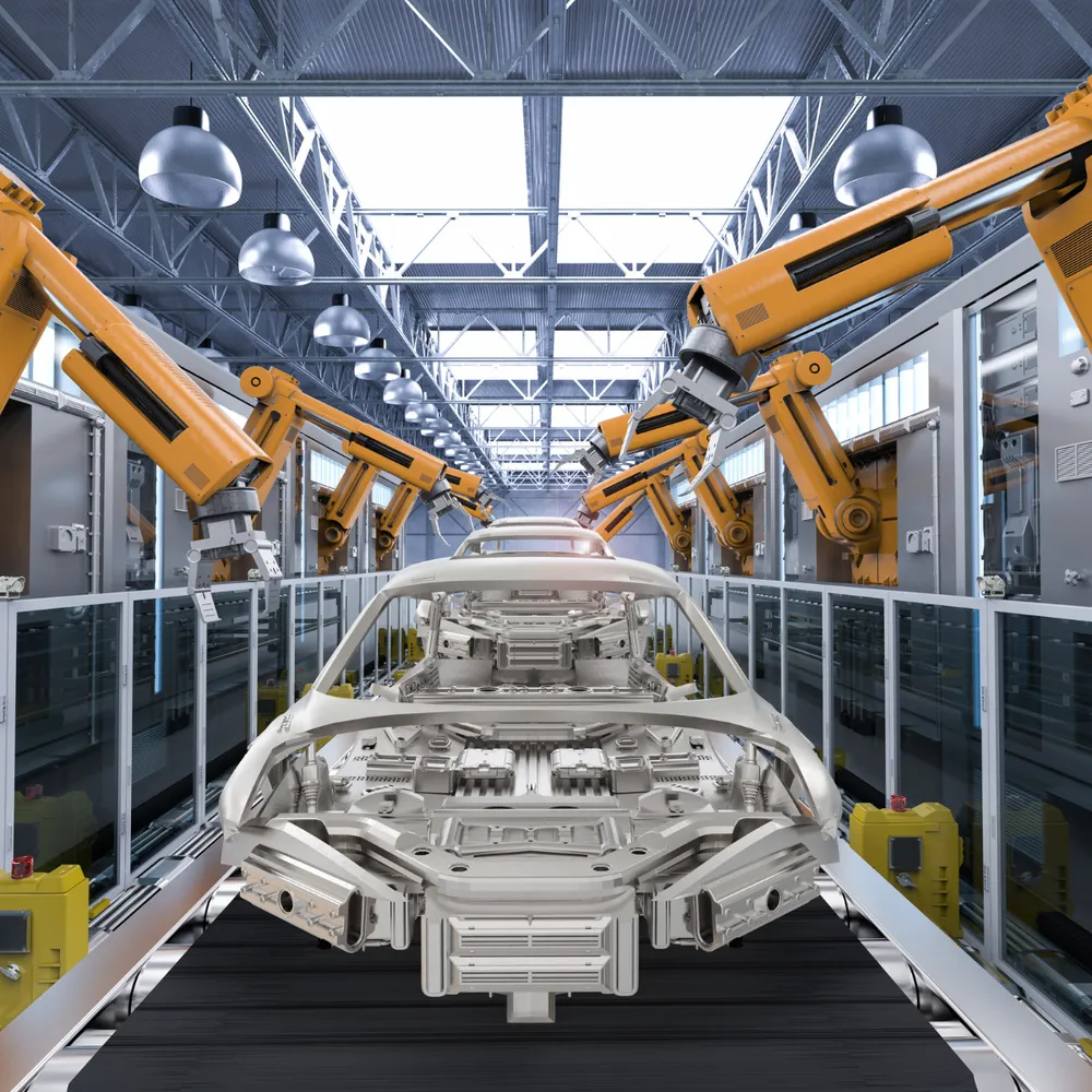 Robotic arms over a car body on an assembly line