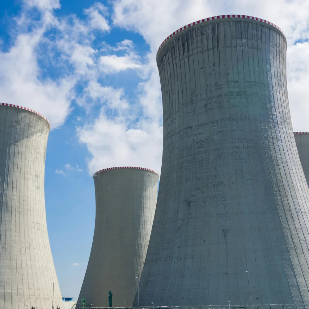 Power station cooling towers against a blue sky